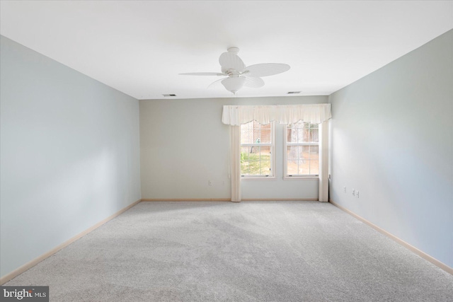 unfurnished room featuring a ceiling fan, baseboards, visible vents, and carpet