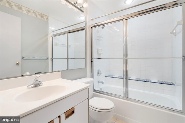 full bathroom with combined bath / shower with glass door, toilet, and vanity