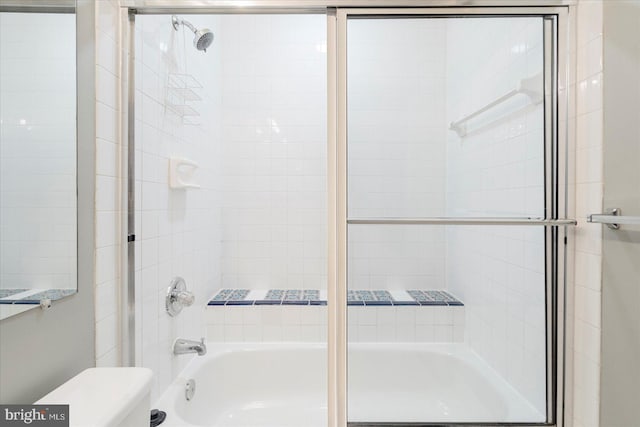 bathroom with bath / shower combo with glass door and toilet