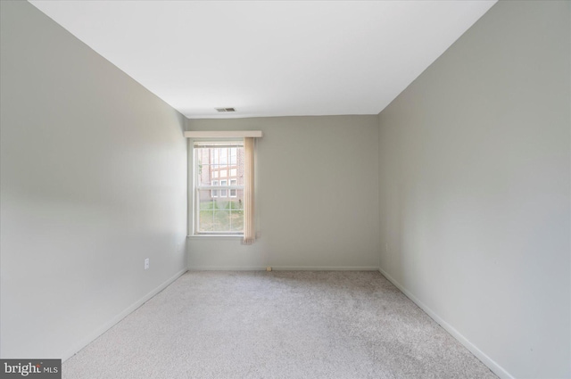 unfurnished room with carpet and baseboards
