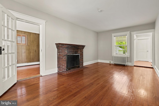331 E Maple Rd, Linthicum Heights, MD 21090 - unfurnished living room with radiator heating unit, a baseboard heating unit, hardwood / wood-style flooring, and plenty of natural light