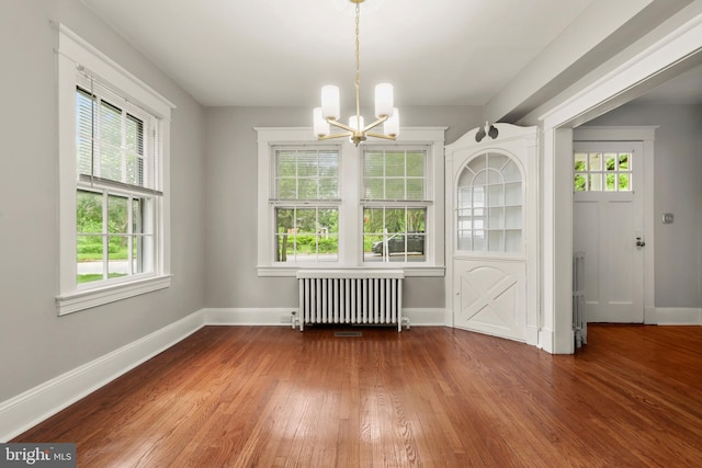 331 E Maple Rd, Linthicum Heights, MD 21090 - unfurnished dining area featuring radiator, a chandelier, hardwood / wood-style flooring, and healthy amount of natural light