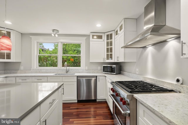 331 E Maple Rd, Linthicum Heights, MD 21090 - kitchen featuring stainless steel appliances, a sink, wall chimney range hood, dark wood-style floors, and white cabinets