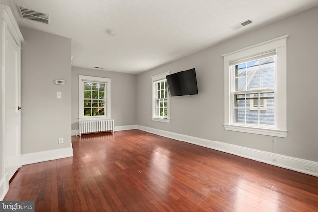 331 E Maple Rd, Linthicum Heights, MD 21090 - unfurnished living room with radiator heating unit, wood-type flooring, and baseboards