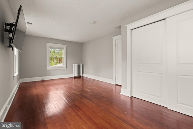 331 E Maple Rd, Linthicum Heights, MD 21090 - unfurnished living room with radiator, hardwood / wood-style floors, and baseboards