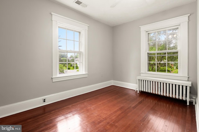 331 E Maple Rd, Linthicum Heights, MD 21090 - empty room featuring radiator heating unit, hardwood / wood-style floors, healthy amount of natural light, and baseboards