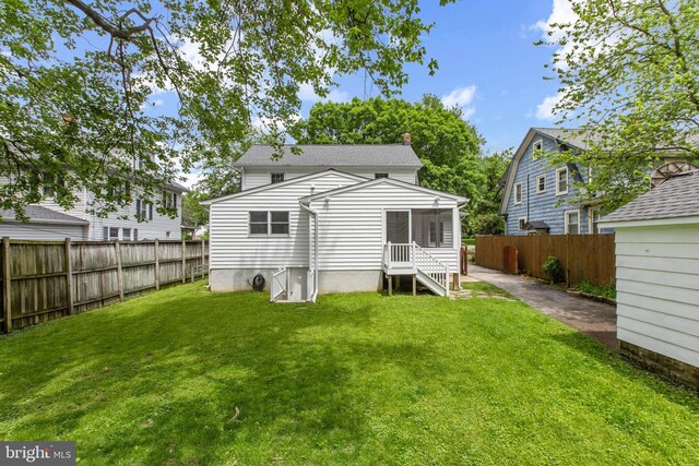 331 E Maple Rd, Linthicum Heights, MD 21090 - back of house with a sunroom and a chimney