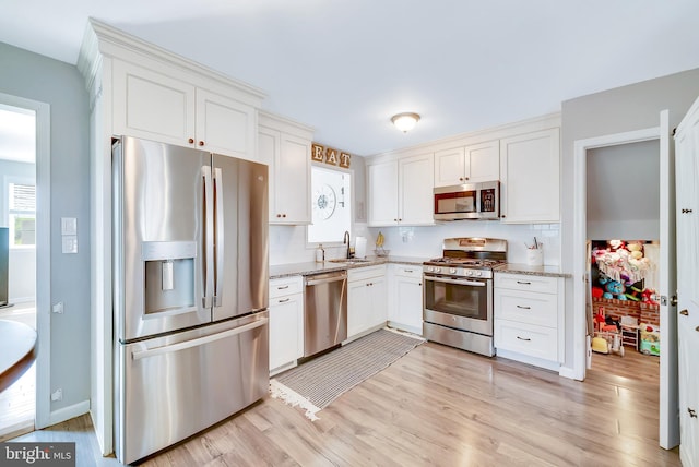 40 Robarts Dr, Phoenixville, PA 19460 - kitchen with appliances with stainless steel finishes, light stone countertops, and white cabinetry
