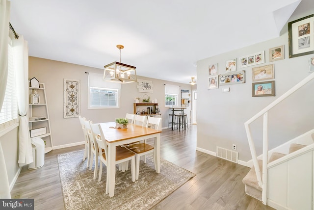 40 Robarts Dr, Phoenixville, PA 19460 - dining space featuring light wood-type flooring, visible vents, stairway, an inviting chandelier, and baseboards