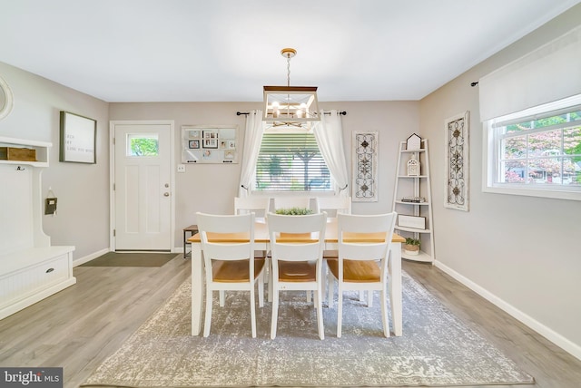40 Robarts Dr, Phoenixville, PA 19460 - dining space with light wood finished floors, a wealth of natural light, and a notable chandelier