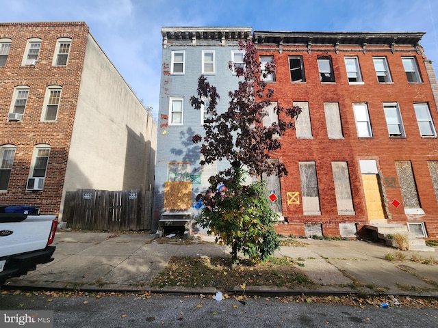 view of building exterior with fence