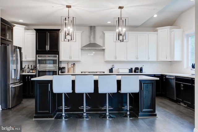4902 Bridle Ridge Rd, Upper Marlboro, MD 20772 - kitchen with a breakfast bar, wall chimney exhaust hood, light countertops, a center island, and appliances with stainless steel finishes