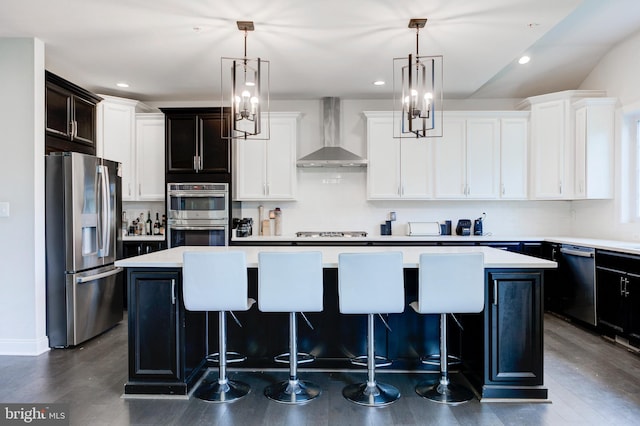 4902 Bridle Ridge Rd, Upper Marlboro, MD 20772 - kitchen featuring a kitchen island, light countertops, wall chimney exhaust hood, and stainless steel appliances