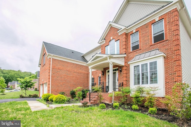 4902 Bridle Ridge Rd, Upper Marlboro, MD 20772 - traditional home with a porch, a garage, a front lawn, and brick siding