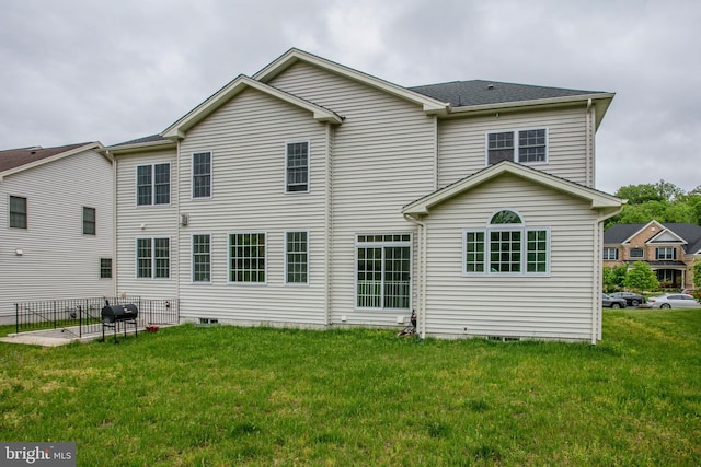 4902 Bridle Ridge Rd, Upper Marlboro, MD 20772 - back of property with a patio, roof with shingles, and a lawn
