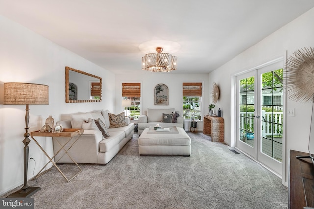 32469 Approach Way Unit 3296, Millsboro, DE 19966 - living area featuring an inviting chandelier, visible vents, and carpet floors