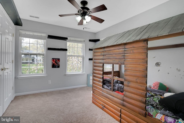 bedroom featuring baseboards, visible vents, and carpet