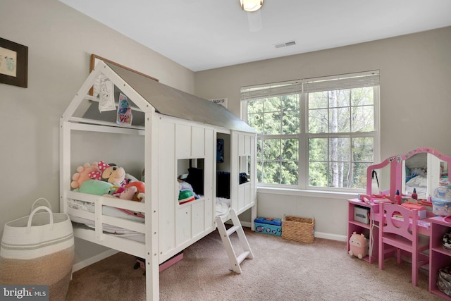 carpeted bedroom featuring visible vents and baseboards