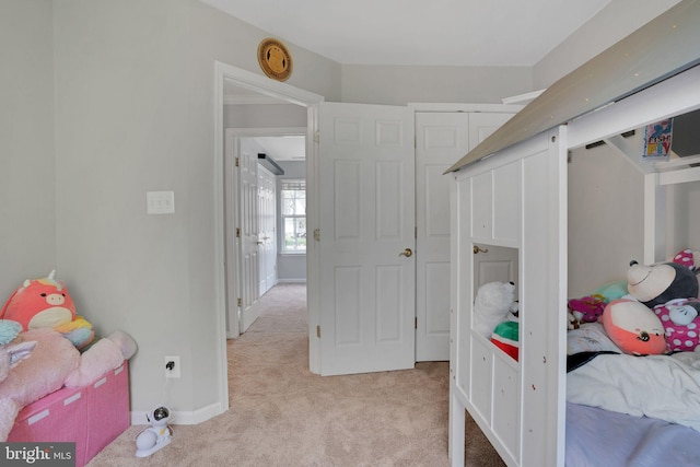 bedroom with carpet flooring and baseboards