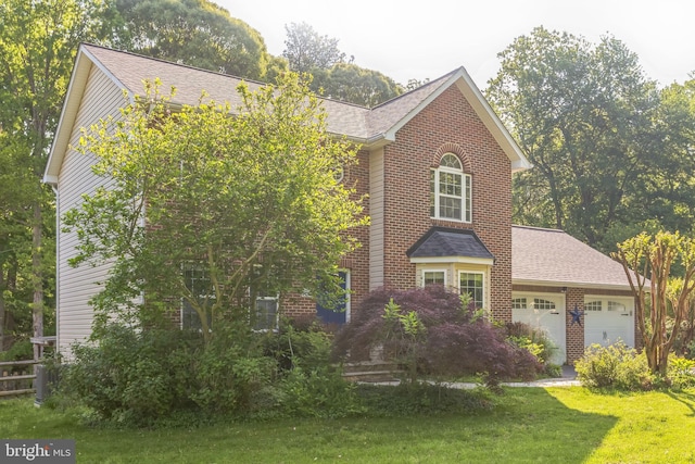 view of front of home with roof with shingles, an attached garage, a front lawn, and brick siding
