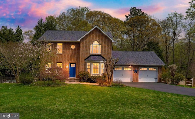 view of front of property with driveway, brick siding, fence, an attached garage, and a front lawn