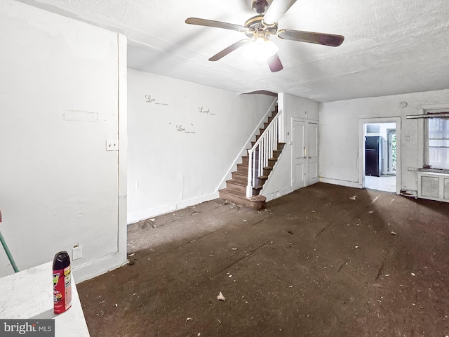 1837 W Juniata St, Philadelphia, PA 19140 - unfurnished living room with stairway, ceiling fan, baseboards, and a textured ceiling