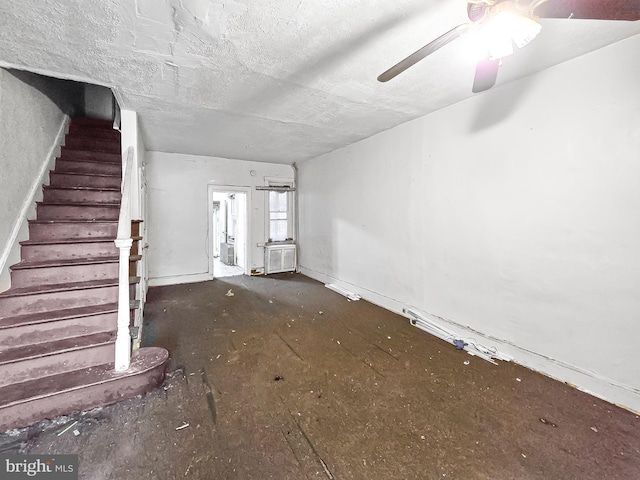 1837 W Juniata St, Philadelphia, PA 19140 - unfurnished living room featuring stairs, a ceiling fan, and a textured ceiling