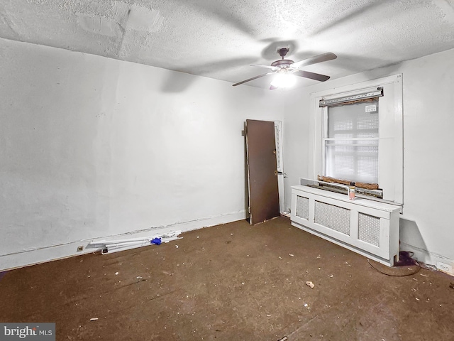 1837 W Juniata St, Philadelphia, PA 19140 - empty room with radiator heating unit, a ceiling fan, a textured ceiling, and concrete floors