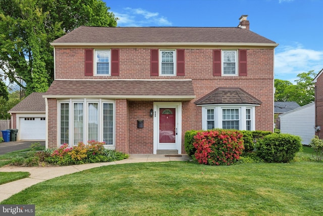 949 Laurance Ave, Elkins Park, PA 19027 - view of front facade with a chimney, a front yard, brick siding, a garage, and a shingled roof