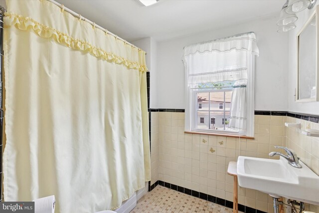 949 Laurance Ave, Elkins Park, PA 19027 - bathroom featuring a wainscoted wall, a sink, tile walls, and a shower with curtain