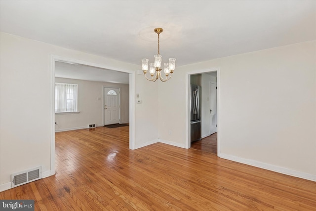 949 Laurance Ave, Elkins Park, PA 19027 - unfurnished dining area with a chandelier, light wood-type flooring, and baseboards