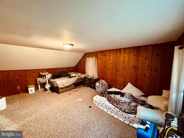 bedroom with wooden walls, carpet, and vaulted ceiling