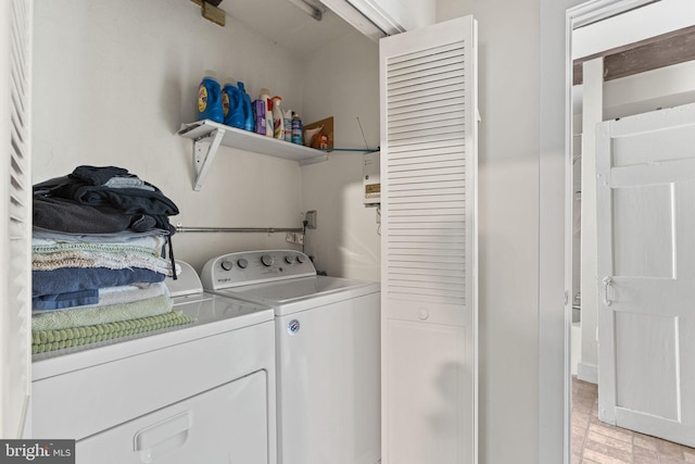 washroom featuring washing machine and dryer and laundry area