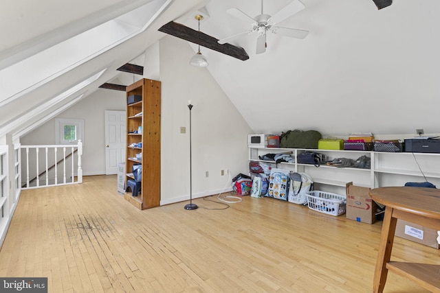 additional living space with ceiling fan, wood-type flooring, lofted ceiling with beams, and baseboards