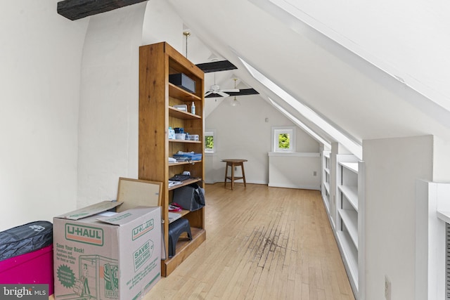 additional living space with lofted ceiling with beams and hardwood / wood-style floors
