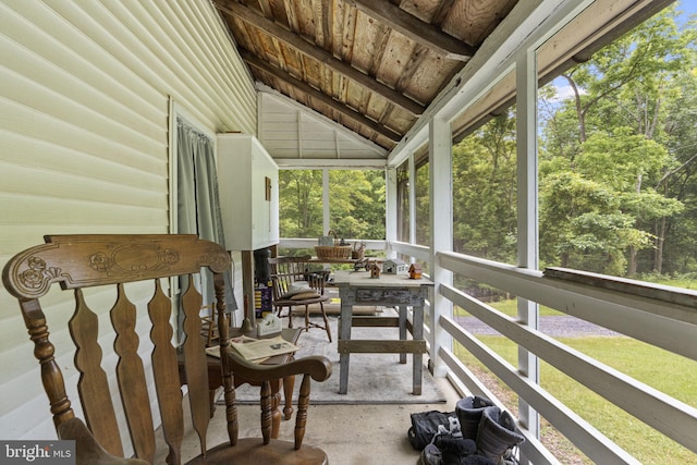 sunroom / solarium featuring lofted ceiling, plenty of natural light, and wooden ceiling