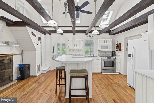 kitchen featuring white appliances, light wood-style flooring, visible vents, and white cabinets