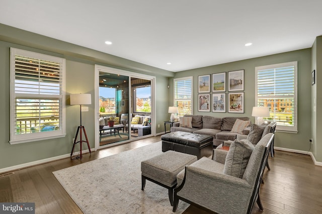 living room with baseboards, wood finished floors, and recessed lighting