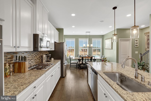 kitchen featuring a sink, stainless steel appliances, white cabinetry, dark wood-type flooring, and recessed lighting