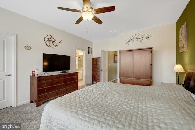 bedroom featuring carpet, baseboards, ensuite bathroom, and ceiling fan
