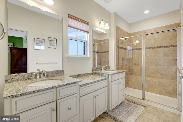 bathroom with a shower stall, vanity, and tile patterned floors