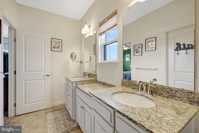 ensuite bathroom featuring two vanities and tile patterned floors