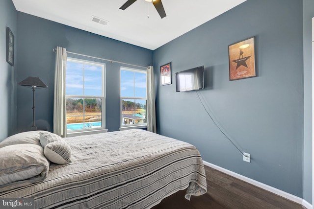 bedroom with wood finished floors, baseboards, and ceiling fan