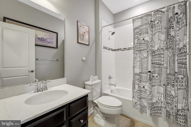 bathroom with toilet, shower / tub combo, and vanity