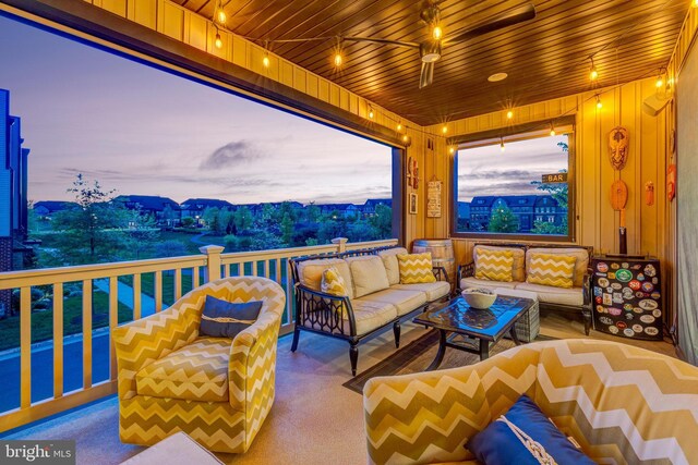 balcony at dusk featuring an outdoor hangout area