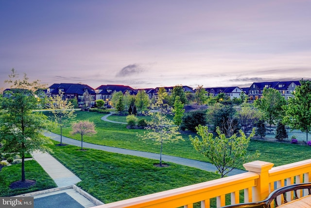 view of property's community featuring a residential view and a lawn