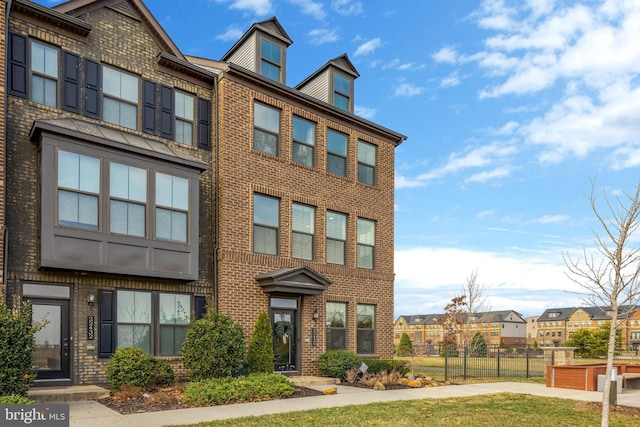 townhome / multi-family property featuring brick siding and a residential view