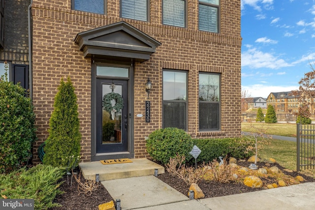 doorway to property with brick siding