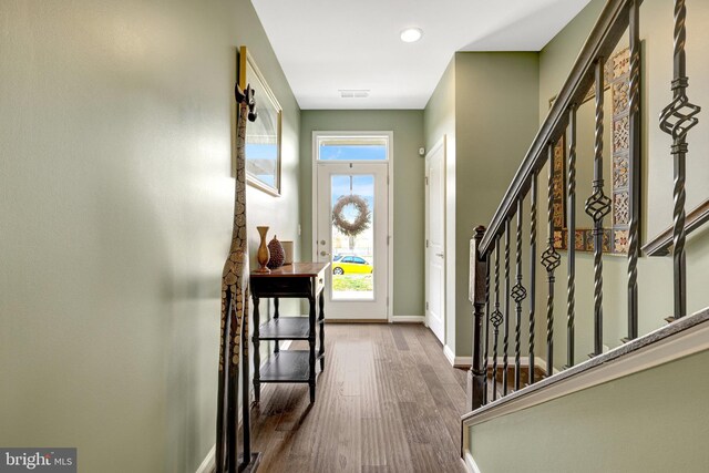 entrance foyer with wood finished floors, stairway, baseboards, and recessed lighting
