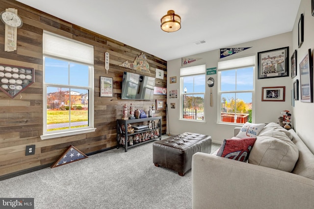 living room with wooden walls and carpet flooring